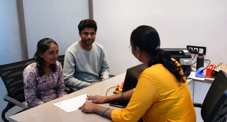 An admissions counsellor speaking with a student and parent