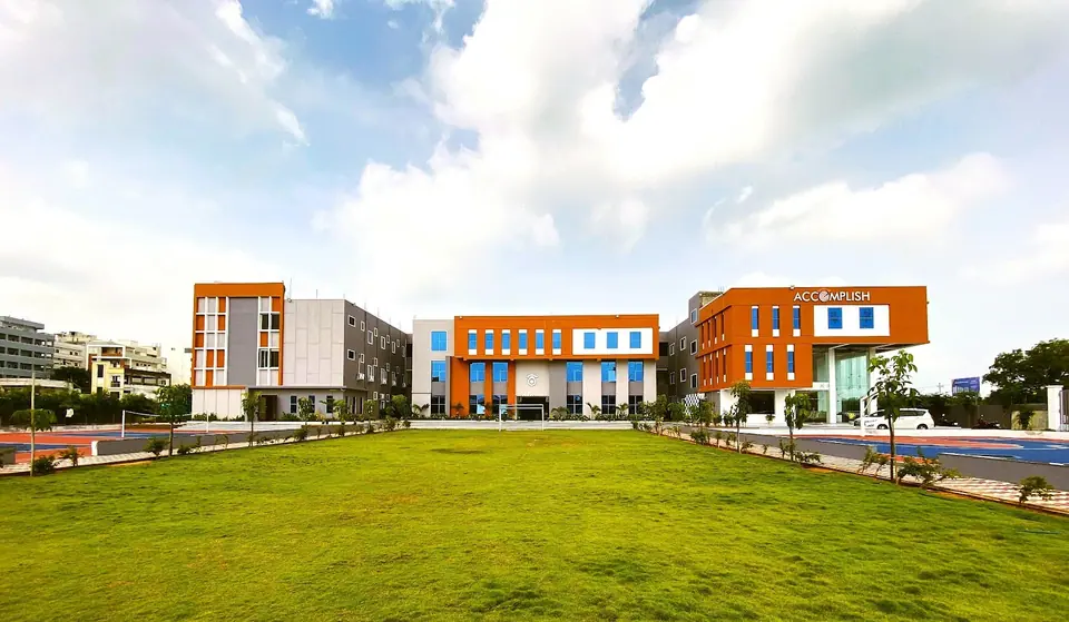 A panoramic view of the Accomplish campus and its green sports field