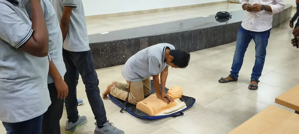 A student practising CPR on a training mannequin
