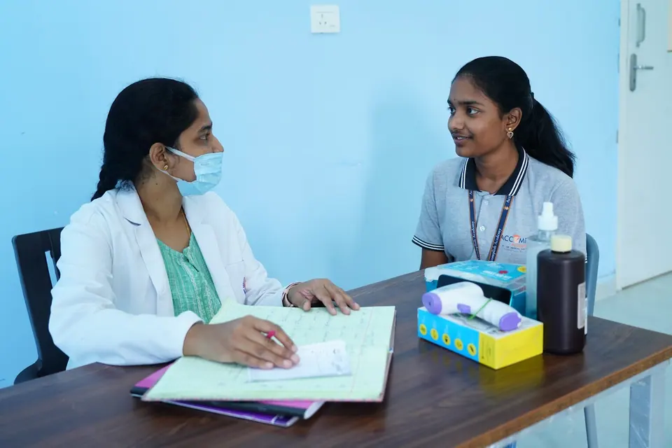 A doctor talking with a student in the campus medical room