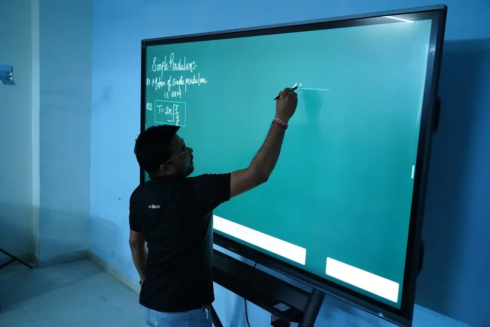 A teacher writing on the interactive smart board