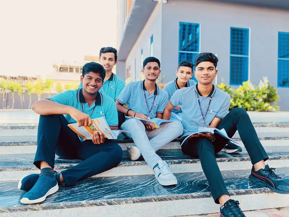 Friends sharing a moment on the campus steps