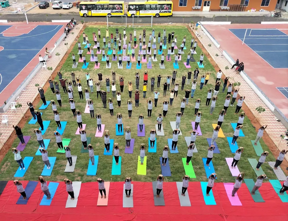 An aerial view of students doing yoga on colourful mats